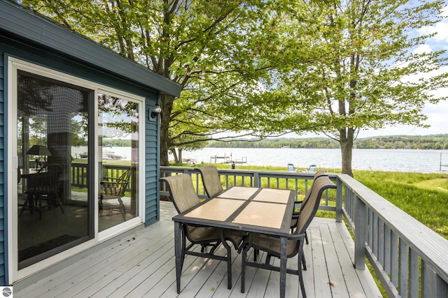 3802 S Grants Lndg, Lake Leelanau, MI 49653 - wooden terrace with a water view and outdoor dining area