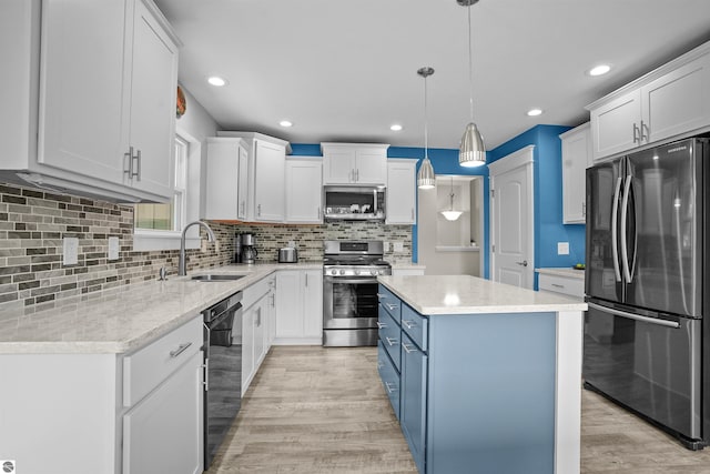 9207 Mockingbird Ln, Cadillac, MI 49601 - kitchen with appliances with stainless steel finishes, a sink, light wood-type flooring, white cabinetry, and blue cabinetry