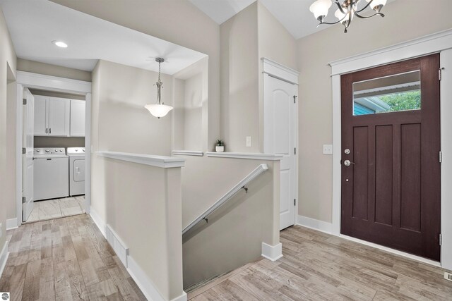 9207 Mockingbird Ln, Cadillac, MI 49601 - foyer entrance with independent washer and dryer, light wood-type flooring, a chandelier, baseboards, and recessed lighting