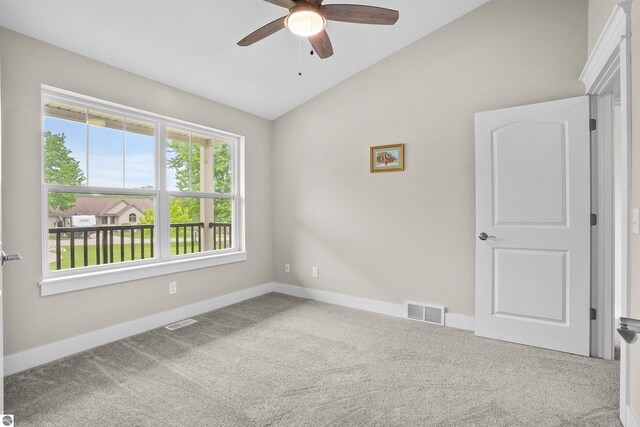 9207 Mockingbird Ln, Cadillac, MI 49601 - unfurnished room featuring lofted ceiling, a ceiling fan, carpet floors, and baseboards
