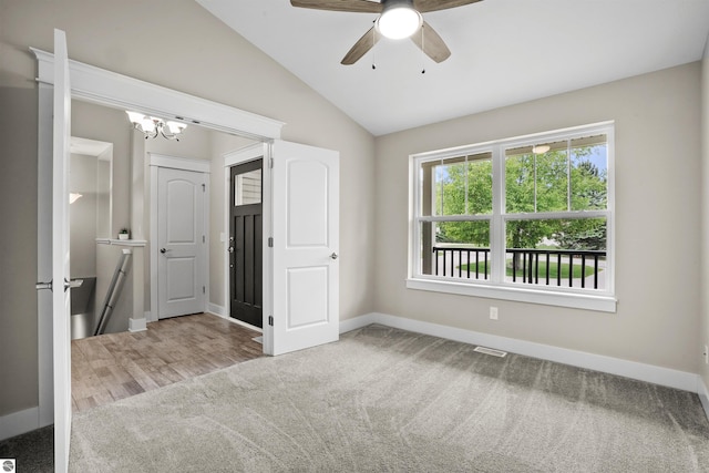 9207 Mockingbird Ln, Cadillac, MI 49601 - unfurnished bedroom featuring carpet floors, lofted ceiling, baseboards, a chandelier, and a ceiling fan