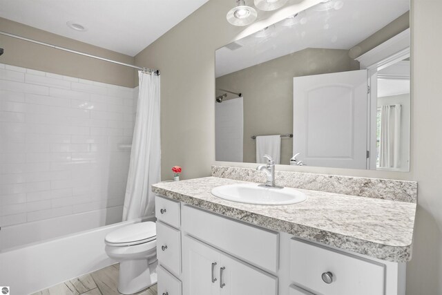 9207 Mockingbird Ln, Cadillac, MI 49601 - bathroom featuring vanity, shower / bath combo, toilet, and wood finished floors