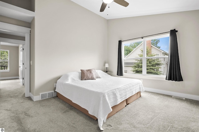 9207 Mockingbird Ln, Cadillac, MI 49601 - carpeted bedroom featuring baseboards, a ceiling fan, and vaulted ceiling