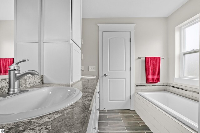 9207 Mockingbird Ln, Cadillac, MI 49601 - full bathroom featuring double vanity and a bath