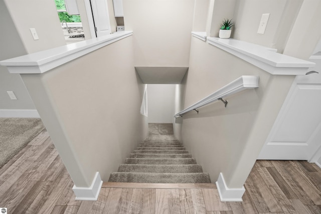9207 Mockingbird Ln, Cadillac, MI 49601 - stairway featuring wood finished floors and baseboards