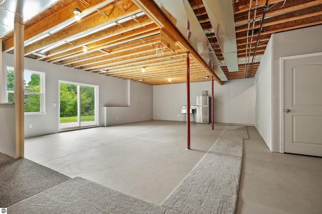 9207 Mockingbird Ln, Cadillac, MI 49601 - below grade area featuring freestanding refrigerator