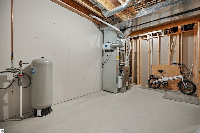 9207 Mockingbird Ln, Cadillac, MI 49601 - unfinished below grade area with a water pressure tank and heating unit