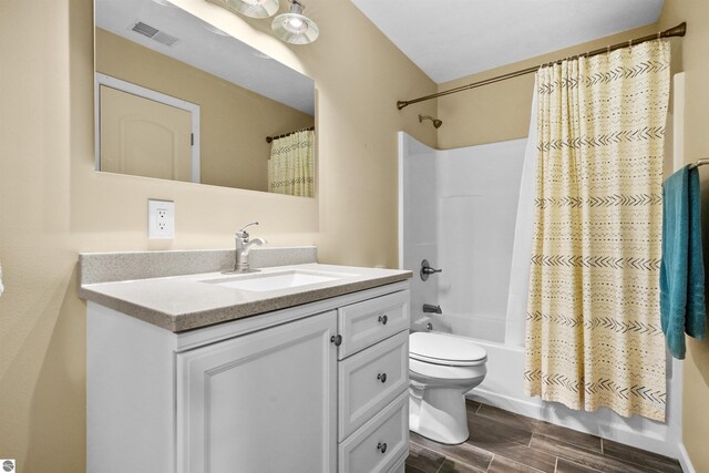 9207 Mockingbird Ln, Cadillac, MI 49601 - bathroom featuring vanity, toilet, shower / bathtub combination with curtain, and wood finished floors