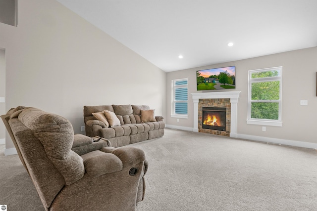 9207 Mockingbird Ln, Cadillac, MI 49601 - carpeted living area with a tile fireplace, baseboards, recessed lighting, and vaulted ceiling
