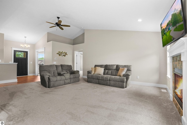 9207 Mockingbird Ln, Cadillac, MI 49601 - living area with a tile fireplace, carpet flooring, ceiling fan, a chandelier, and baseboards