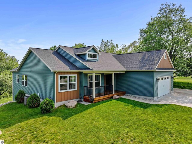 9207 Mockingbird Ln, Cadillac, MI 49601 - view of front of home with a garage, a porch, driveway, and a front lawn