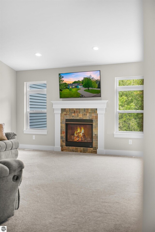 9207 Mockingbird Ln, Cadillac, MI 49601 - carpeted living room with baseboards, a fireplace, and recessed lighting