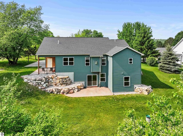9207 Mockingbird Ln, Cadillac, MI 49601 - back of property with a patio and a lawn