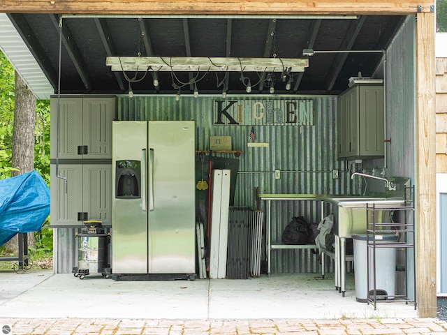 100 Fence Row Cir, Leroy, MI 49655 - garage with stainless steel fridge with ice dispenser