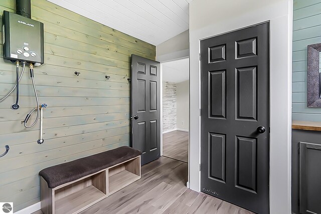 100 Fence Row Cir, Leroy, MI 49655 - mudroom with light wood-type flooring, wooden walls, and baseboards