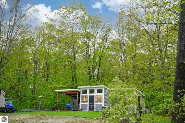 100 Fence Row Cir, Leroy, MI 49655 - view of yard with a forest view