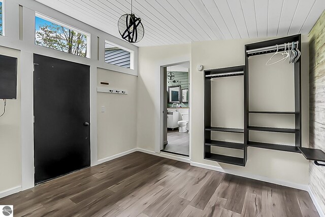 100 Fence Row Cir, Leroy, MI 49655 - unfurnished bedroom with wood finished floors, wood ceiling, and baseboards