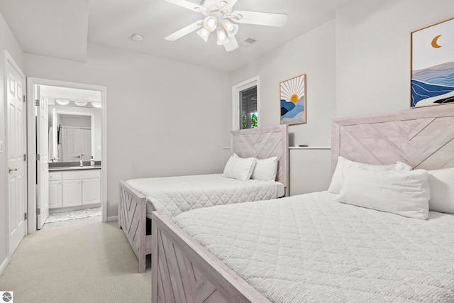 4492 Forest Trl, Bellaire, MI 49615 - bedroom with light carpet, a sink, ensuite bath, a ceiling fan, and baseboards