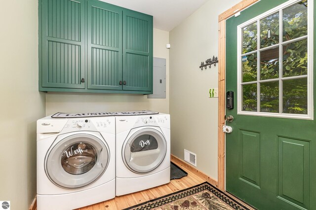 1715 Sunrise Dr, Greenbush, MI 48738 - laundry area featuring cabinet space, washer and dryer, wood finished floors, and healthy amount of natural light