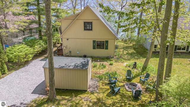 1715 Sunrise Dr, Greenbush, MI 48738 - back of property featuring a fire pit