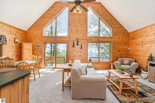 1715 Sunrise Dr, Greenbush, MI 48738 - living area with high vaulted ceiling, carpet floors, wooden walls, and ceiling fan