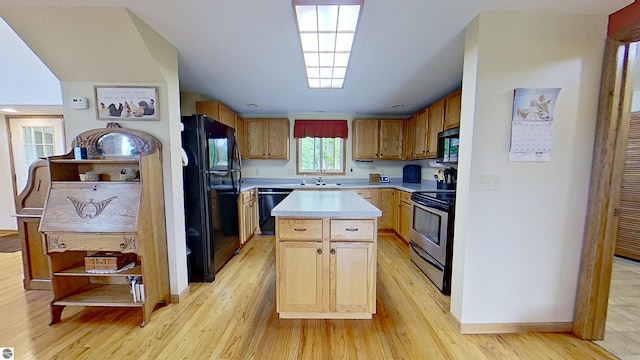 9755 E Deerfield Rd, Shepherd, MI 48883 - kitchen featuring black appliances, light countertops, light wood-style floors, a center island, and baseboards