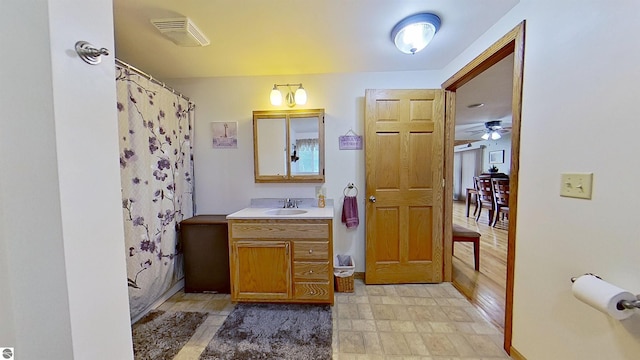 9755 E Deerfield Rd, Shepherd, MI 48883 - bathroom with vanity, a ceiling fan, and a shower with curtain