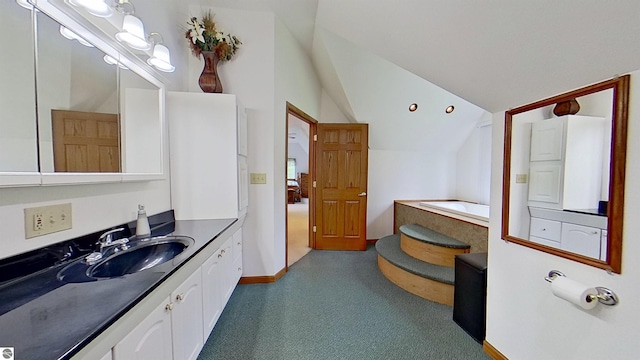 9755 E Deerfield Rd, Shepherd, MI 48883 - full bath with lofted ceiling, vanity, a bath, and baseboards