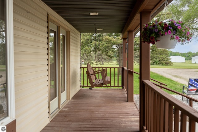 9755 E Deerfield Rd, Shepherd, MI 48883 - wooden porch featuring a lawn