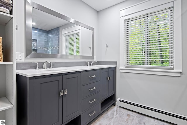 2664 Chandler Rd, Traverse City, MI 49686 - full bathroom featuring a baseboard radiator, double vanity, and tiled shower