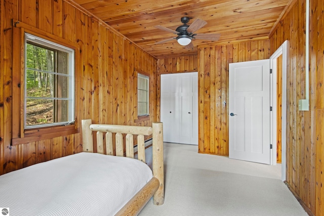 2664 Chandler Rd, Traverse City, MI 49686 - bedroom featuring carpet, wooden walls, wood ceiling, and baseboard heating