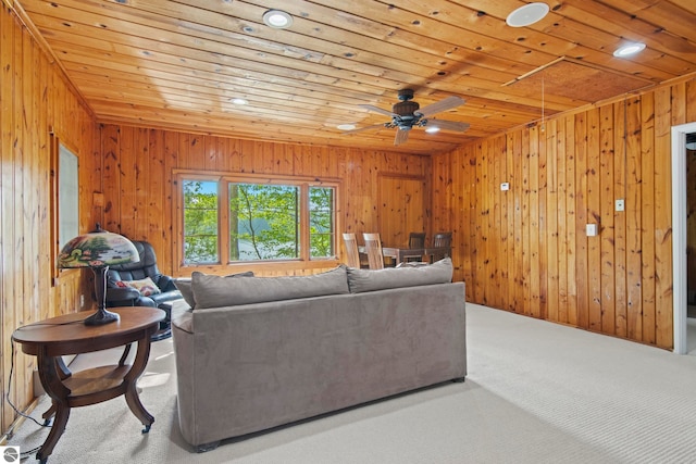 2664 Chandler Rd, Traverse City, MI 49686 - living room featuring wood ceiling, carpet, wooden walls, a ceiling fan, and recessed lighting