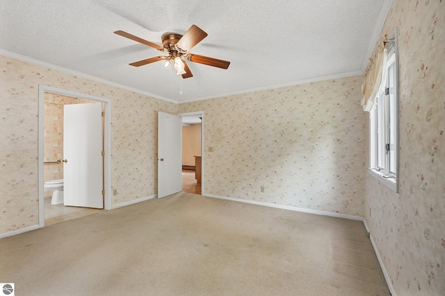 9017 Clam Lake Rd, Bellaire, MI 49615 - unfurnished bedroom with ornamental molding, carpet floors, ensuite bath, a ceiling fan, and a textured ceiling