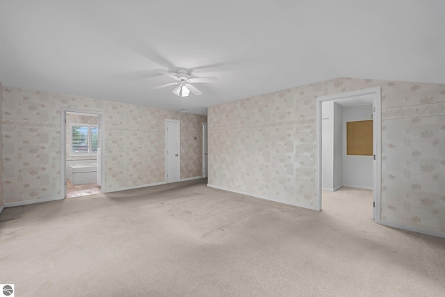 9017 Clam Lake Rd, Bellaire, MI 49615 - empty room with ceiling fan, light carpet, wallpapered walls, and baseboards