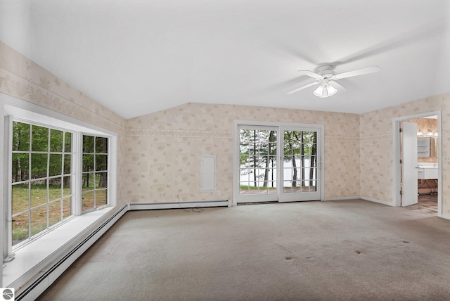 9017 Clam Lake Rd, Bellaire, MI 49615 - spare room with a baseboard heating unit, carpet floors, wallpapered walls, lofted ceiling, and a ceiling fan