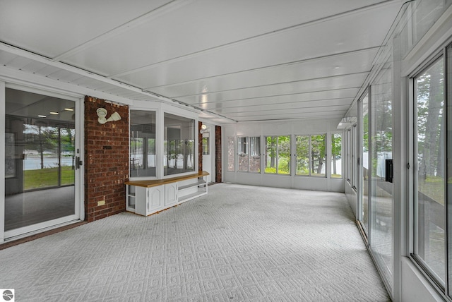 9017 Clam Lake Rd, Bellaire, MI 49615 - unfurnished sunroom featuring carpet floors