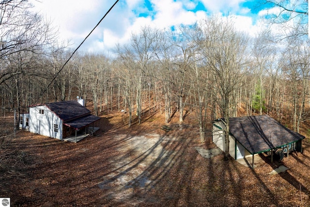 350 Mcmorris Trl, Harrison, MI 48625 - deck featuring an outbuilding and a forest view