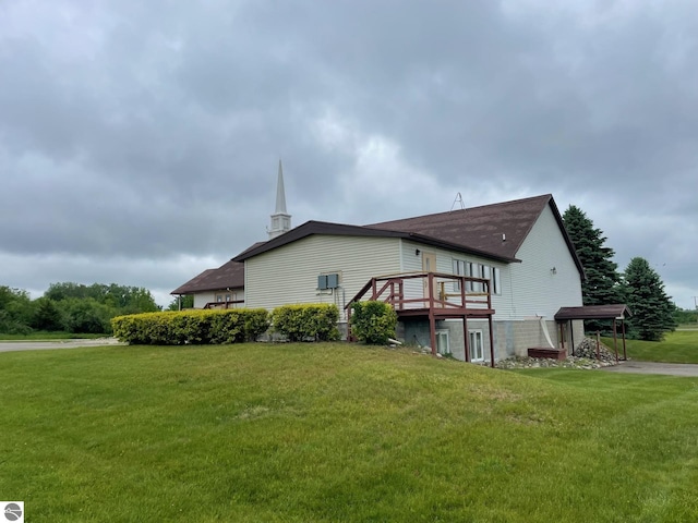 8055 S Castle Dr, Sheridan, MI 48884 - view of property exterior with a wooden deck, a lawn, and a shingled roof