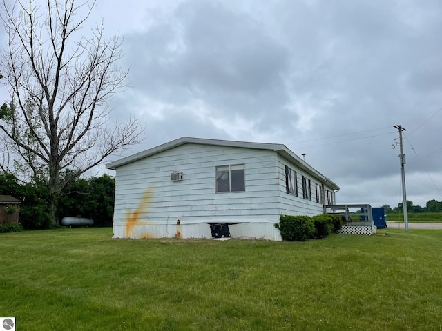 8055 S Castle Dr, Sheridan, MI 48884 - view of side of property featuring a yard