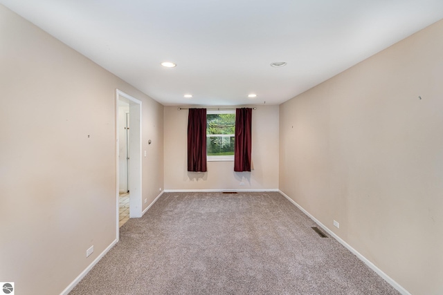 212 Palmer St, Mount Pleasant, MI 48858 - empty room featuring light colored carpet, recessed lighting, and baseboards