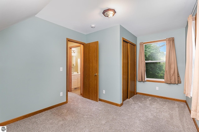 212 Palmer St, Mount Pleasant, MI 48858 - unfurnished bedroom featuring carpet flooring, baseboards, a closet, and lofted ceiling