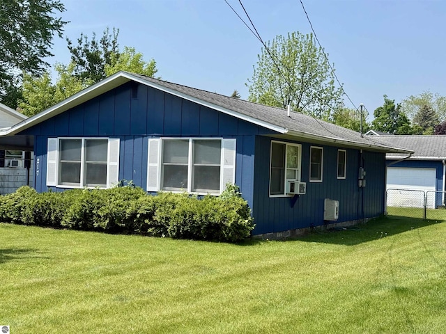 217 Evans St, East Tawas, MI 48730 - view of side of property featuring a garage, board and batten siding, and a shingled roof