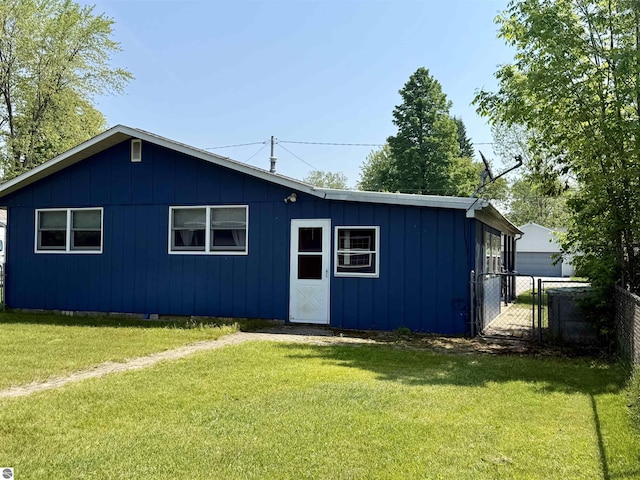 217 Evans St, East Tawas, MI 48730 - view of front of house featuring board and batten siding and a gate