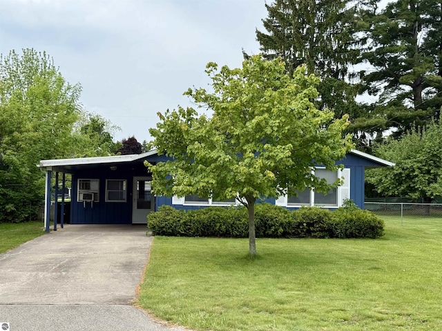 217 Evans St, East Tawas, MI 48730 - view of property hidden behind natural elements featuring driveway and an attached carport
