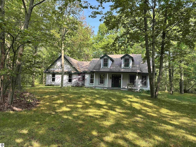 5867 Huron Woods Dr, Tawas City, MI 48763 - cape cod home with covered porch, a front lawn, and roof with shingles