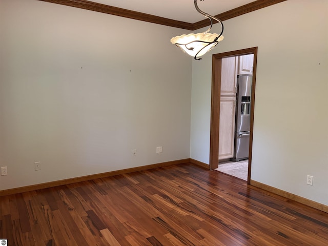 5867 Huron Woods Dr, Tawas City, MI 48763 - unfurnished room with crown molding, baseboards, and wood finished floors