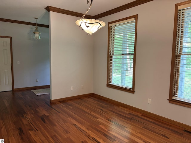 5867 Huron Woods Dr, Tawas City, MI 48763 - empty room featuring ornamental molding, dark wood-style flooring, and baseboards