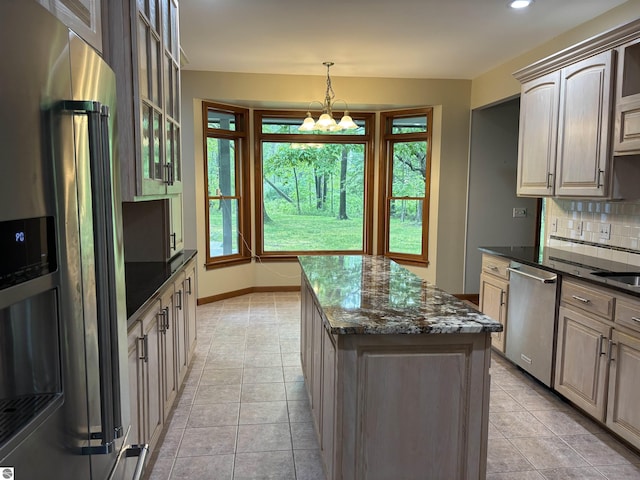 5867 Huron Woods Dr, Tawas City, MI 48763 - kitchen with appliances with stainless steel finishes, a kitchen island, backsplash, and plenty of natural light