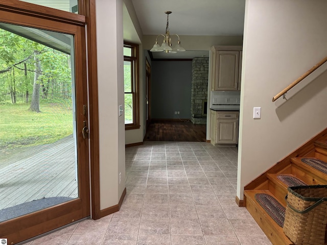 5867 Huron Woods Dr, Tawas City, MI 48763 - foyer entrance with a chandelier, baseboards, lofted ceiling, and light tile patterned floors