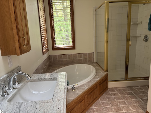 5867 Huron Woods Dr, Tawas City, MI 48763 - bathroom with a sink, a shower stall, a garden tub, and tile patterned floors